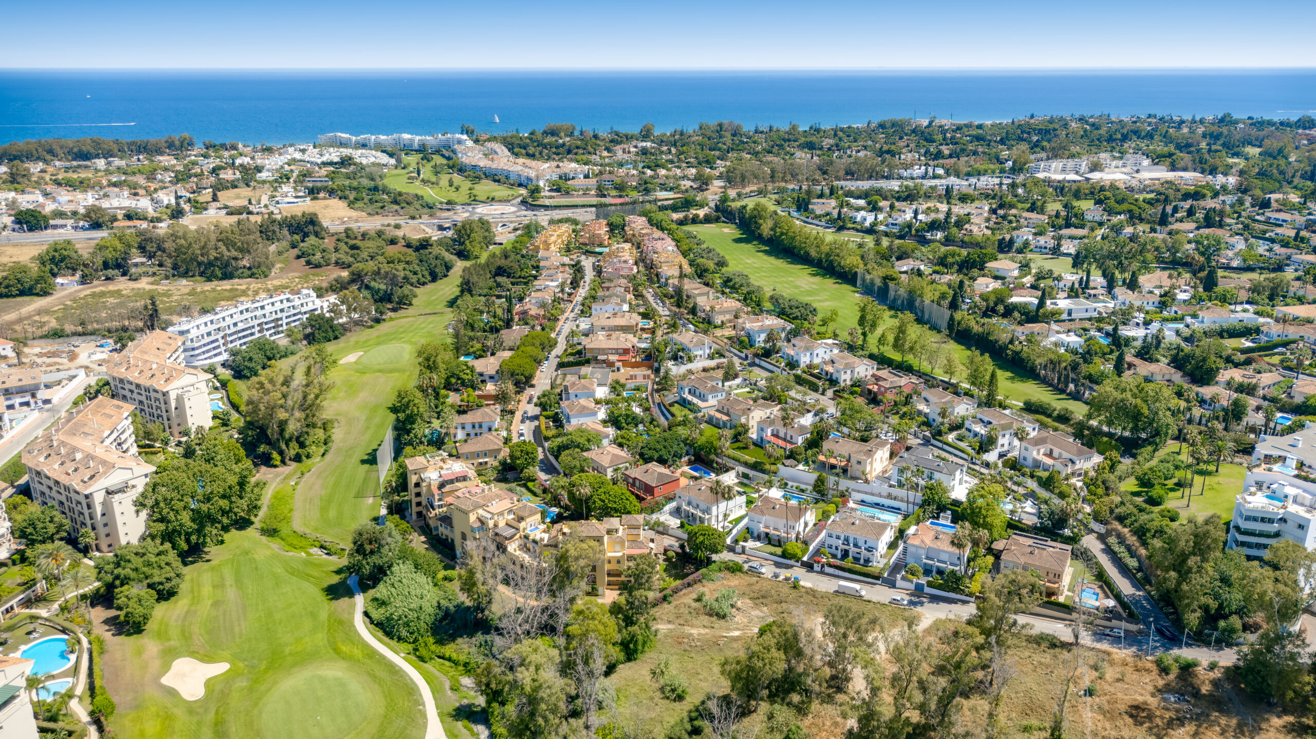 Aerial view of villas beside a golf course on the Costa del Sol coastline