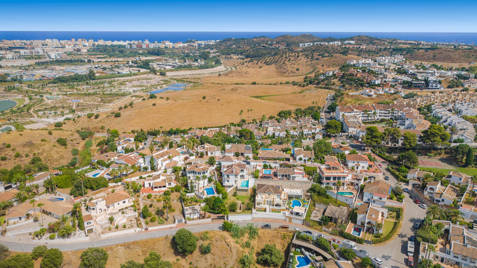 Aerial: villa neighbourhood, sea in distance – Costa del Sol, photo by Your Property Concept
