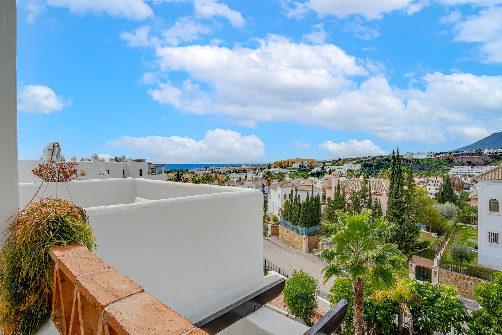 Modern white apartment blocks with gardens and palms – Costa del Sol, photo by Your Property Concept